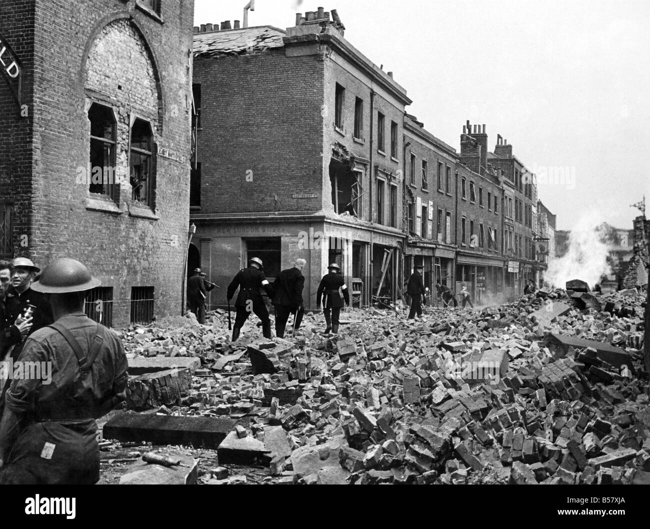 V1 Flying bomb incident at East Smithfield causing damage and casualties - also fractured gas and water mains-the gas main was well alight and although the water was gushing out almost along-side it the heat was terrific. Troops were quatered on the Thames Bank but escaped with slight injuries. August 1944 P009475 Stock Photo
