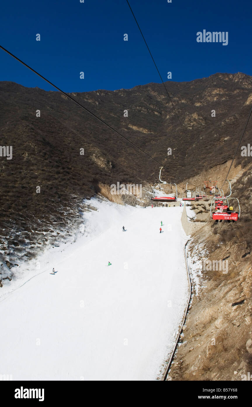 A ski lift taking skiers up to the slopes at Shijinglong ski resort, Beijing, China, Asia Stock Photo
