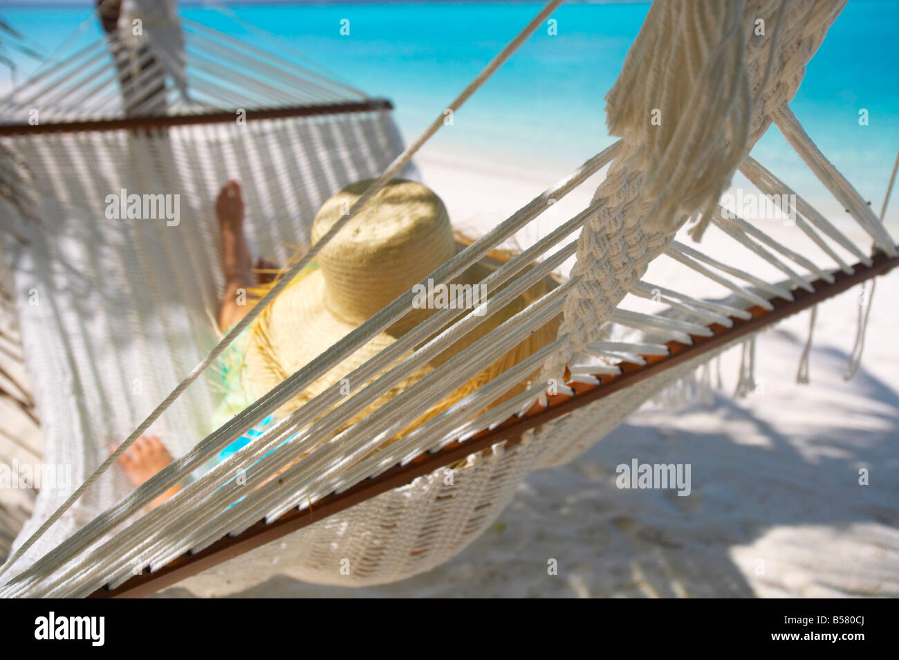 Woman relaxing in a hammock, Maldives, Indian Ocean, Asia Stock Photo