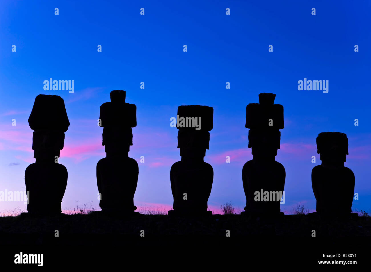 Anakena beach, monolithic giant stone Moai statues of Ahu Nau Nau, Rapa Nui, Chile Stock Photo