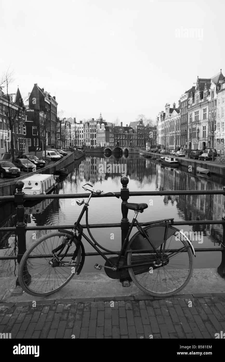 Black and white image of an old bicycle by the Singel canal, Amsterdam, Netherlands, Europe Stock Photo