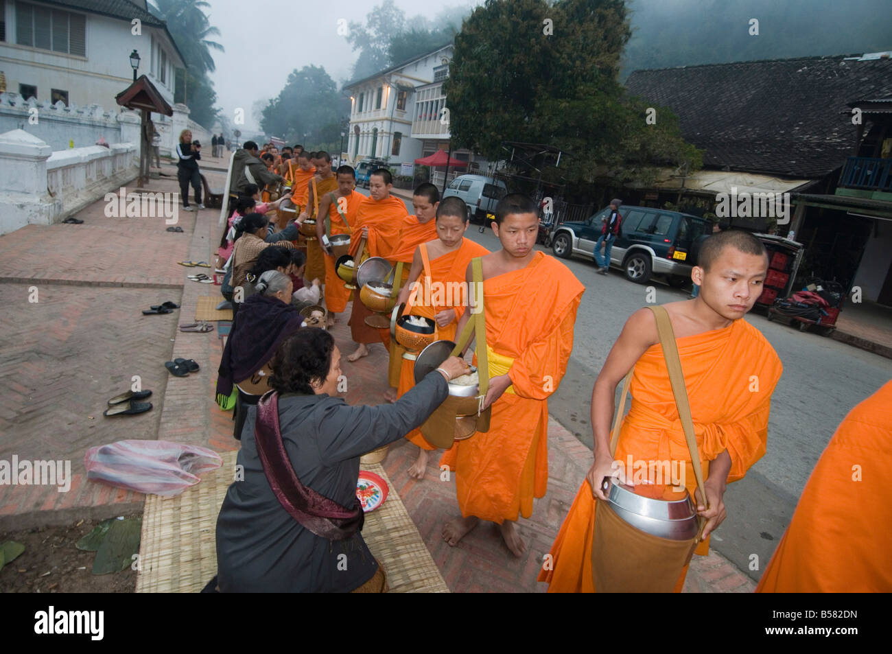Buddhist monks collecting alms in the early morning, Luang Prabang, Laos, Indochina, Southeast Asia, Asia Stock Photo
