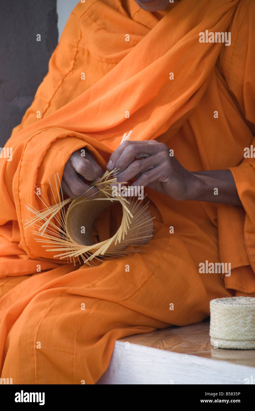 Monk making basket, Laos, Indochina, Southeast Asia, Asia Stock Photo