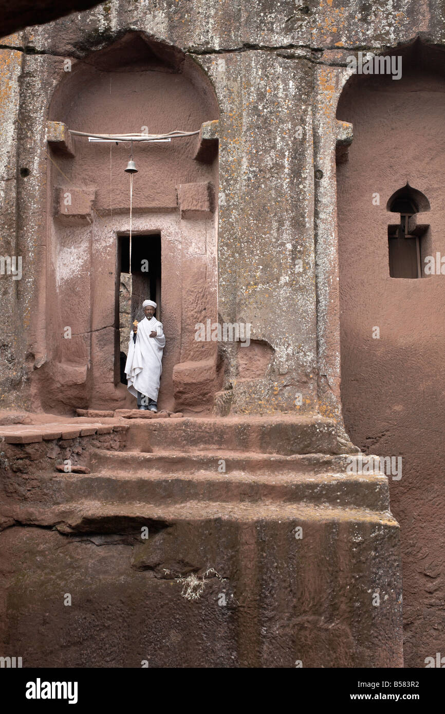 Priest in Bet Danaghel Church holding the Cross of King Lalibela. The  rock-hewn churches of Lalibela make it one of the greatest  Religio-Historical sites not only in Africa but in the Christian