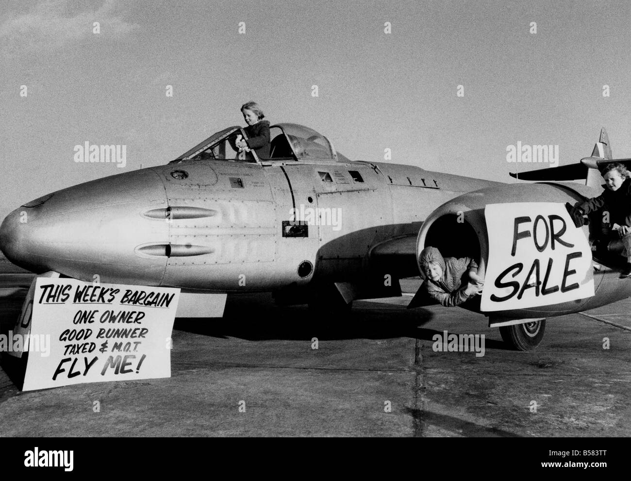 R.A.F. Colerne, Wiltshire, sell off their museum planes. The station is closing at the end of the year 1976. Helping to get a Gloster Meteor aeroplane ready for the sale were 7 year old Tim Browse, 7 year old Sofie Skipsey and 6 year old Michael Bryant. February 1976 P004646 Stock Photo