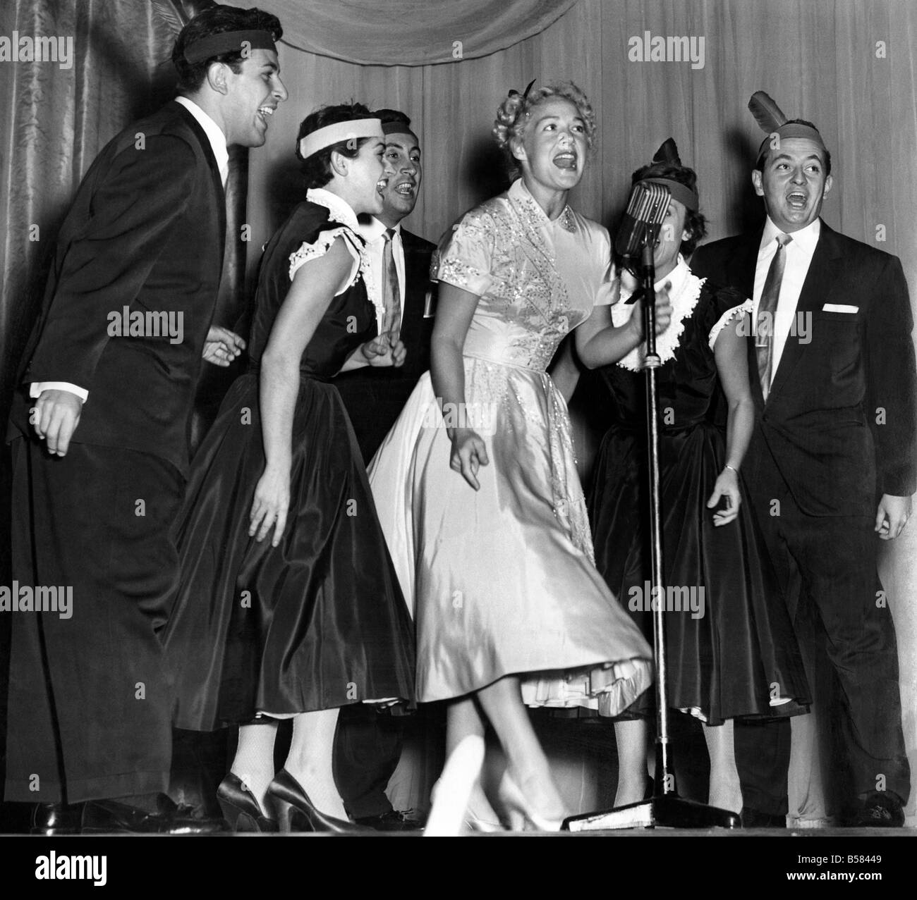 Betty Hutton at Palladium. Betty Hutton who appears at the Palladium tomorrow had a dress rehearsal. Betty Hutton with the Skylarks singing one of her numbers in the show. Earing a yellow full skirted dress. September 1952 P005293 Stock Photo