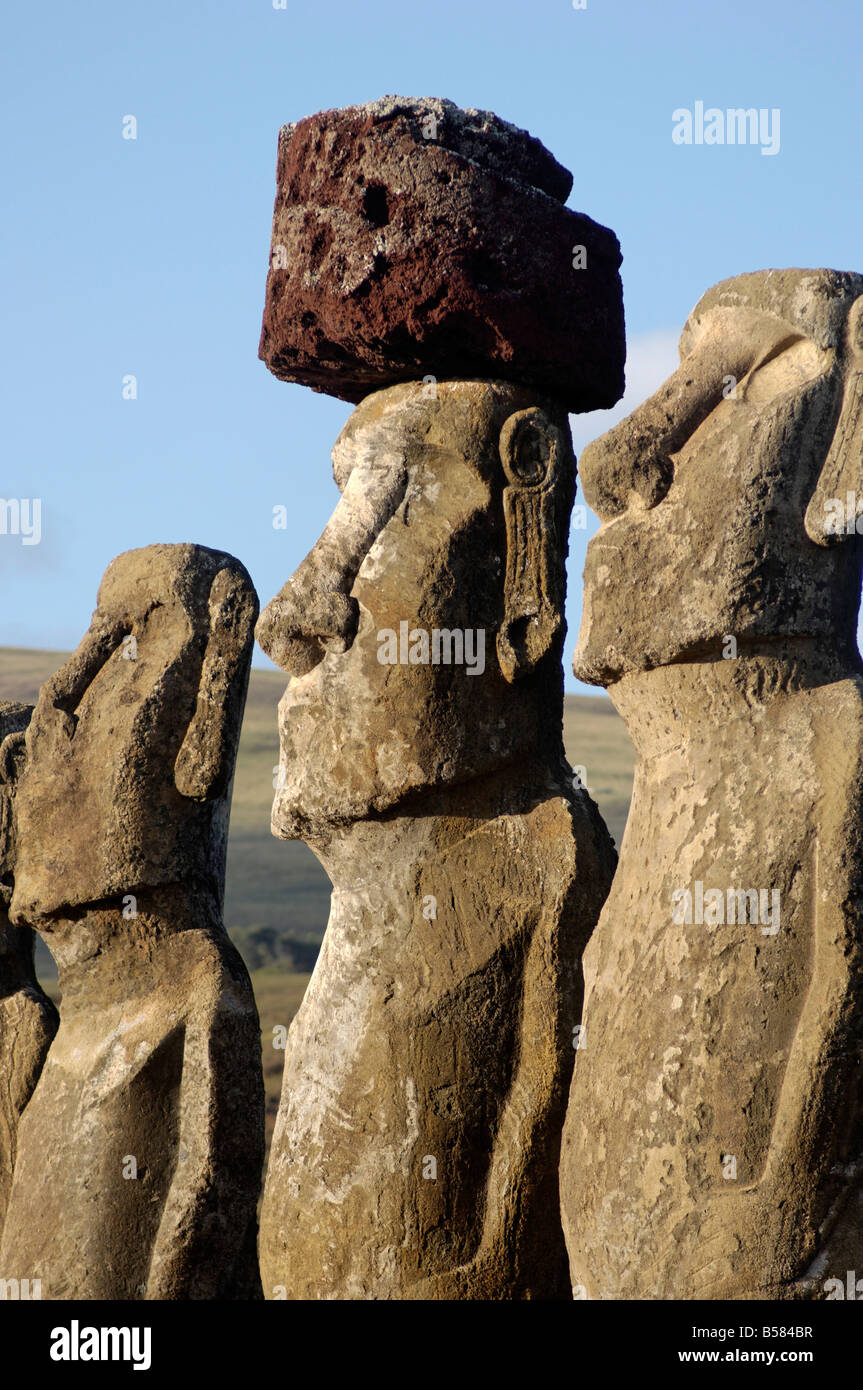 Three of the fifteen huge moai statues standing with their backs to the ocean, Ahu Tongariki, Easter Island, Chile Stock Photo
