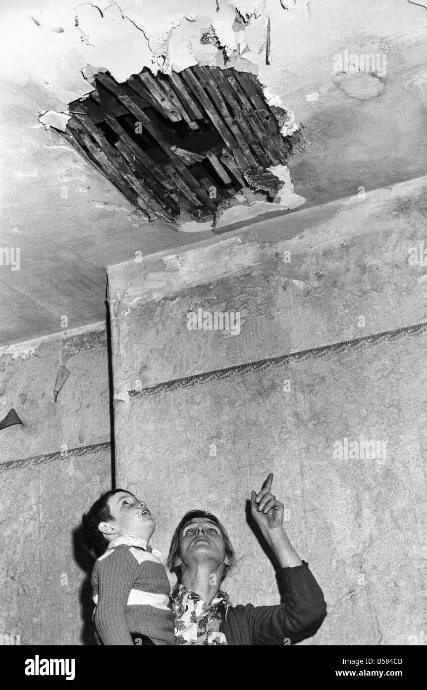Salford has the Worst slums in Europe: Front bedroom of her slum house. The ceiling collapsed. And Mrs. Sloan shows her five yea Stock Photo