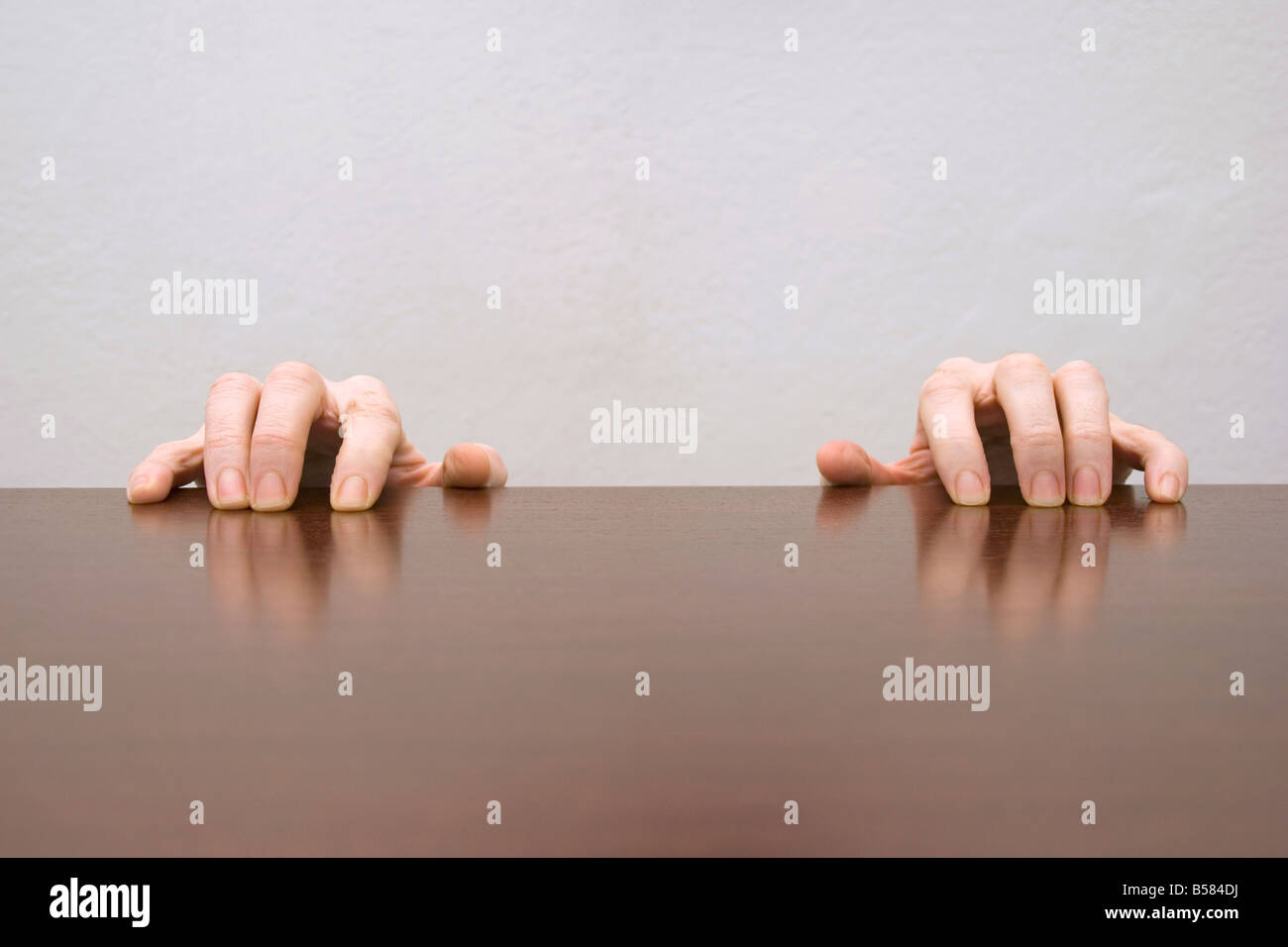 hands grasping table Stock Photo