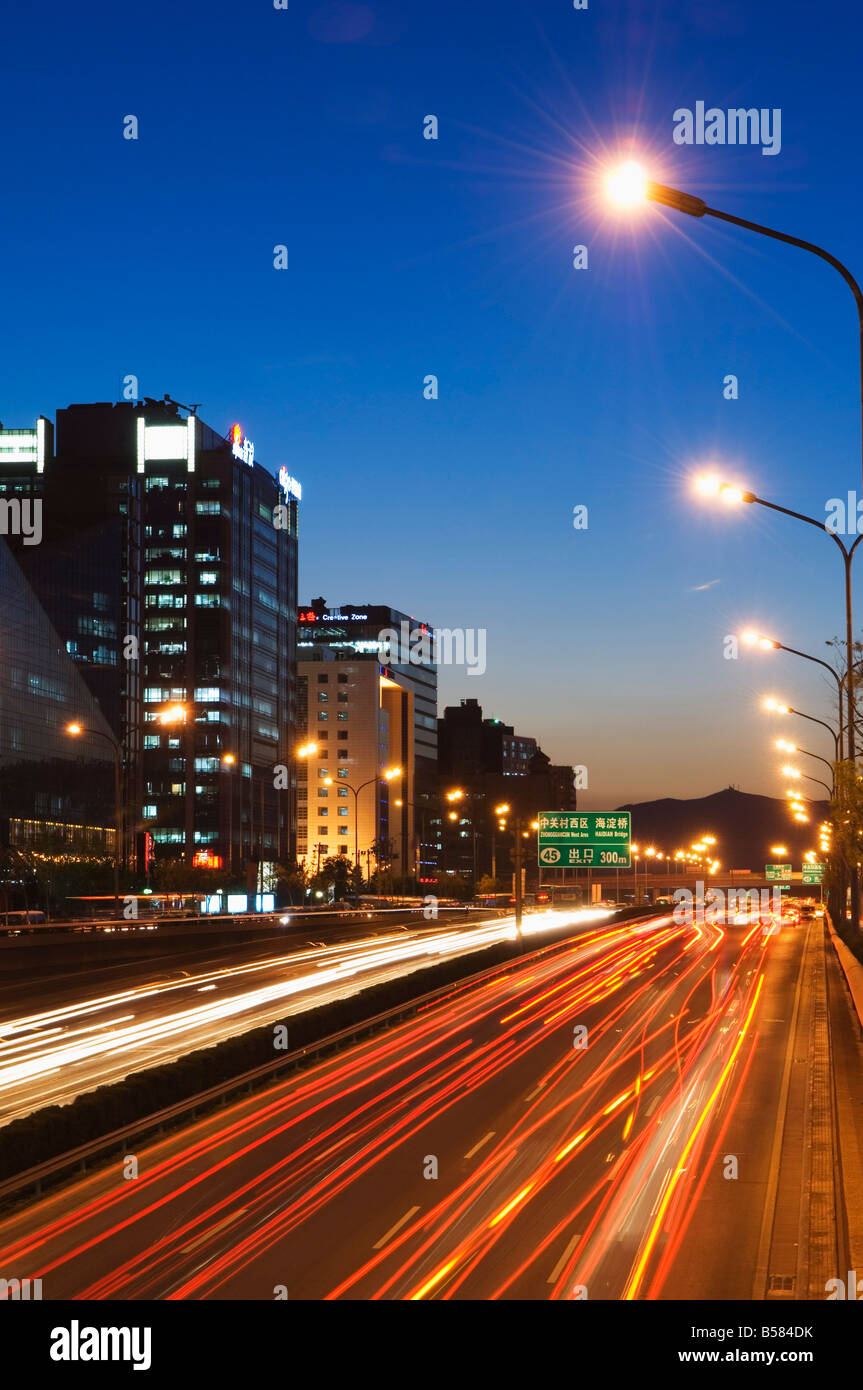 Car light trails and modern architecture on a city ring road, Beijing, China, Asia Stock Photo