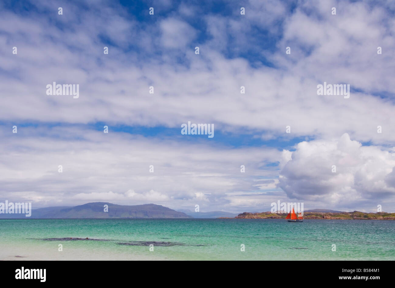 Boat with red sails off Traigh Bhan beach, Iona, Sound of Iona, Scotland, United Kingdom, Europe Stock Photo