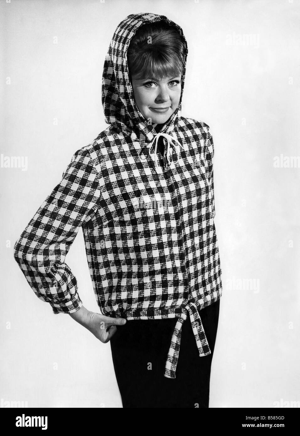 Reveille Fashions 1966: Ann Jarvis wearing check hoodie coat. January 1966 P006671 Stock Photo