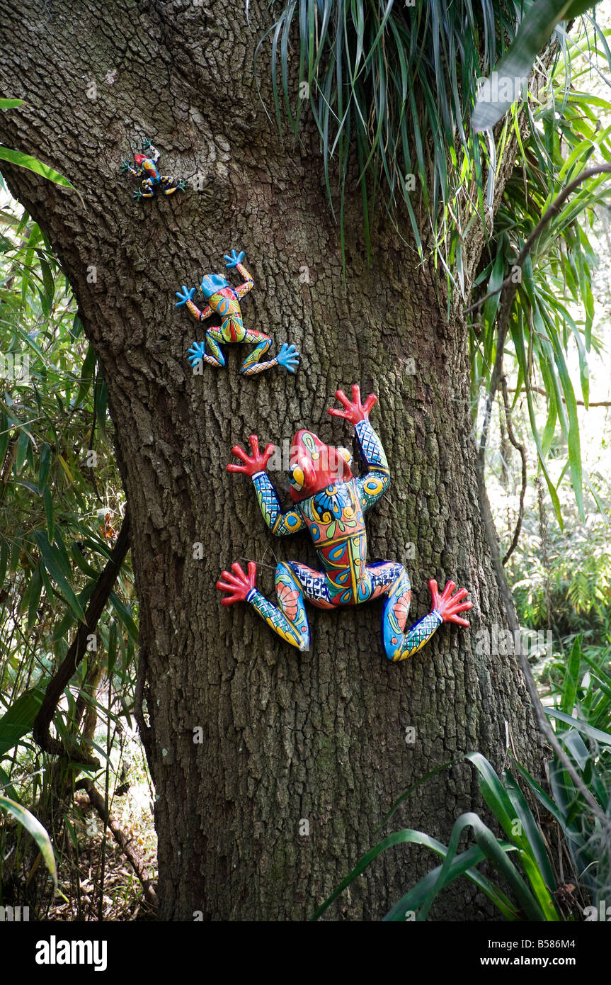 colorful frog garden decorations adorn tree at Kanapaha Gardens