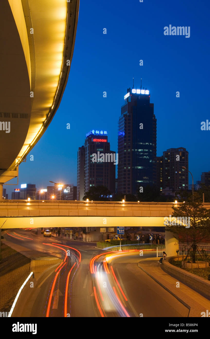 Car light trails and modern buildings near Beijing North Train Station, Xizhimen district, Beijing, China, Asia Stock Photo