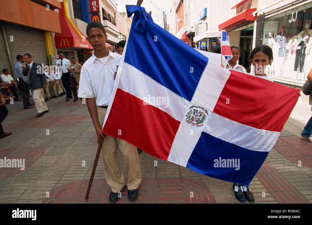School children marching with flag, Santo Domingo, Dominican Republic, West Indies, Central America Stock Photo