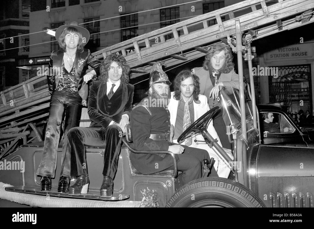 The Slade pop group on fire engine. L to R Dave Hill, Don Powell, Jimmy Lea, Noddy Holder. February 1975 75-00872-001 Stock Photo