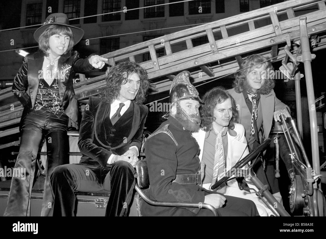 The Slade pop group on fire engine. L to R Dave Hill, Don Powell, Jimmy Lea, Noddy Holder. February 1975 75-00872-002 Stock Photo