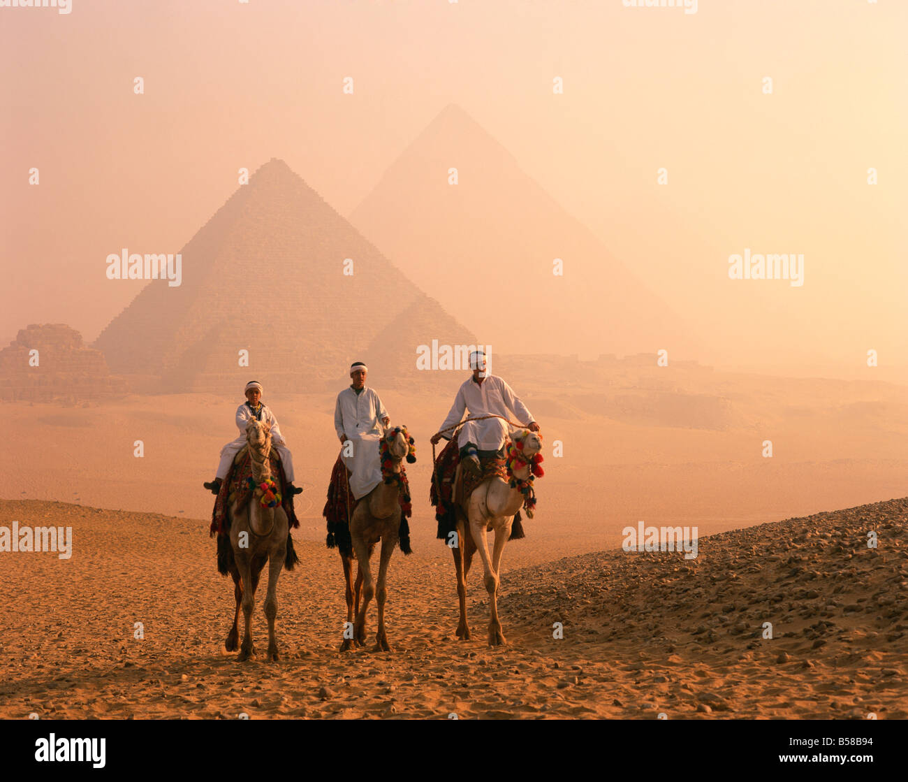 Camel riders at Giza Pyramids UNESCO World Heritage Site Giza Cairo Egypt North Africa Africa Stock Photo