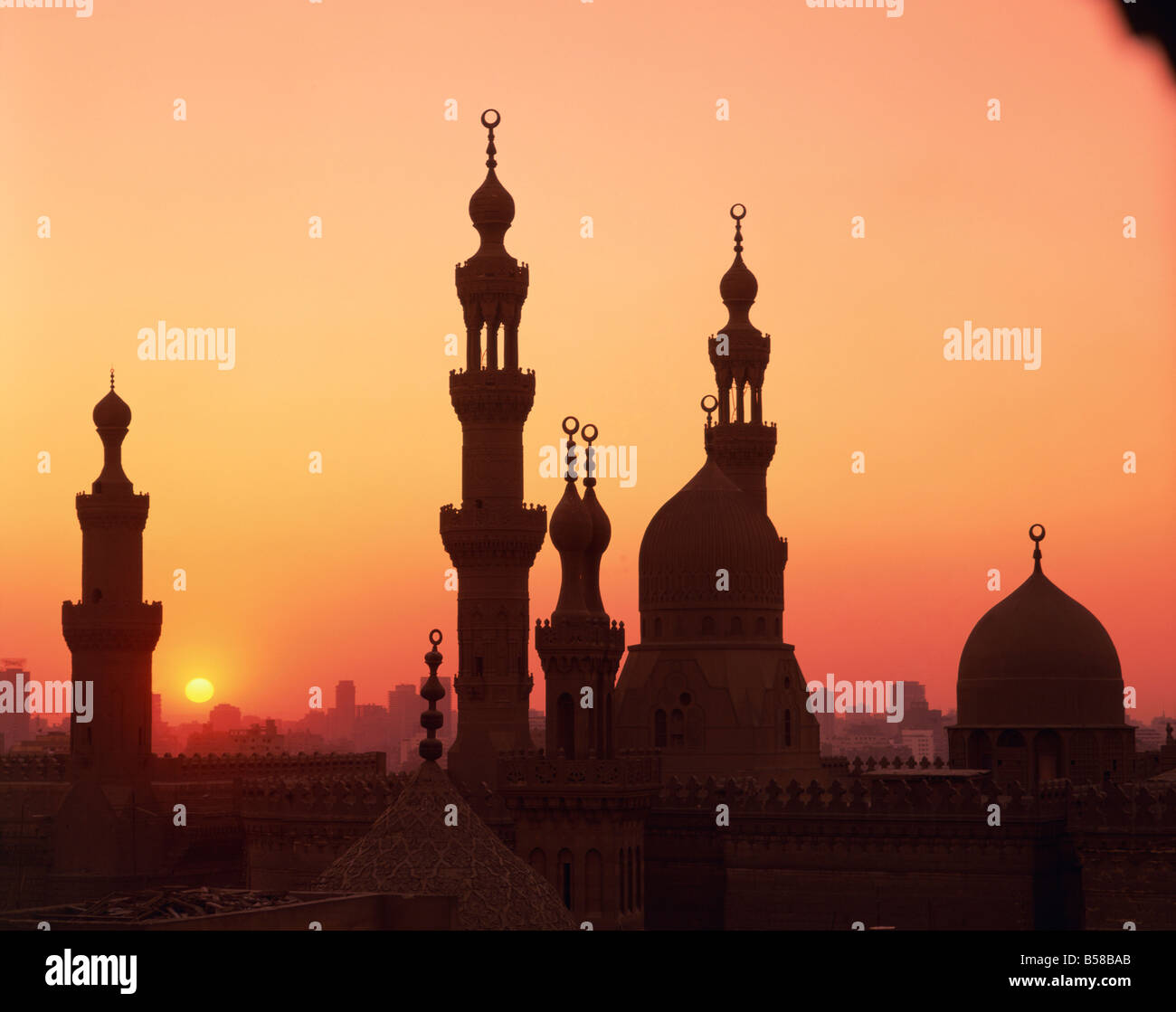 Domes and minarets silhouetted at sunset Cairo Egypt North Africa Africa Stock Photo