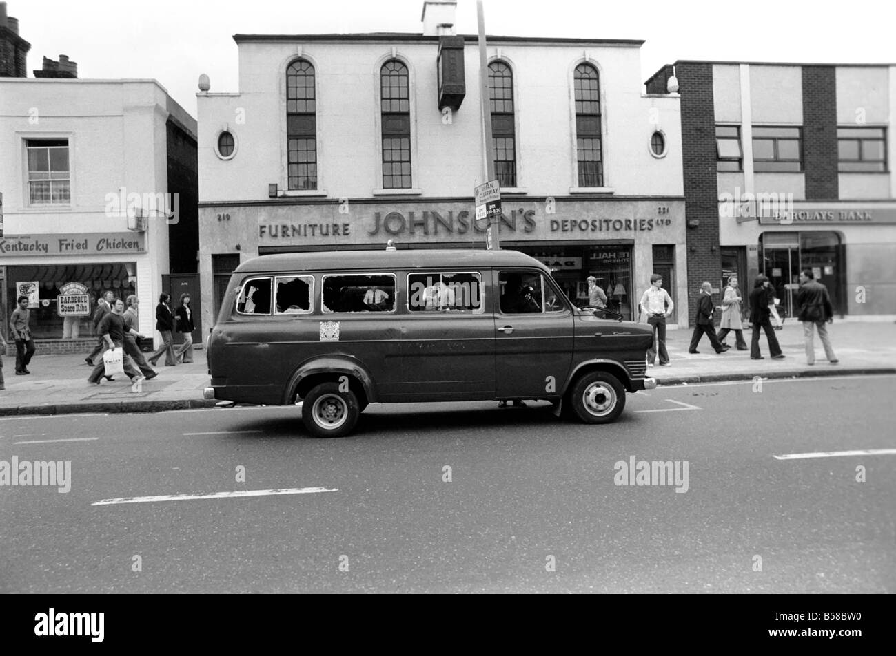 Lewisham Riot 1977 : A police transit van with its windows smashed seen here in Lewisham high street following clashes between extremists on the Right and Left. The riot was sparked by a National Front march through the centre of town, which was confronted by a left wing counter demonstration. August 1977 77-04357-015 Stock Photo