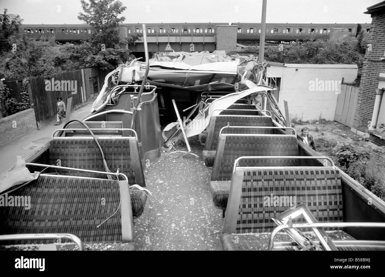 Lewisham Riot 1977 : The remains of a police bus wrecked during the clashes between extremists on the Right and Left. The riot was sparked by a National Front march through the centre of town, which was confronted by a left wing counter demonstration. August 1977 77-04357-023; Stock Photo