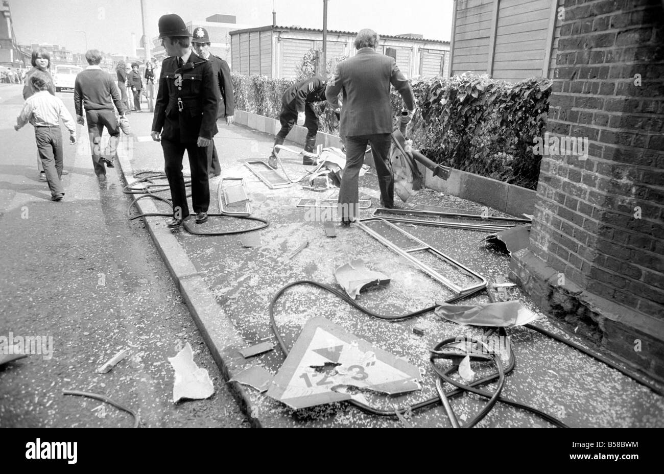 Lewisham Riot 1977 : The remains of a police bus wrecked during the clashes between extremists on the Right and Left. The riot was sparked by a National Front march through the centre of town, which was confronted by a left wing counter demonstration. August 1977 77-04357-024; Stock Photo