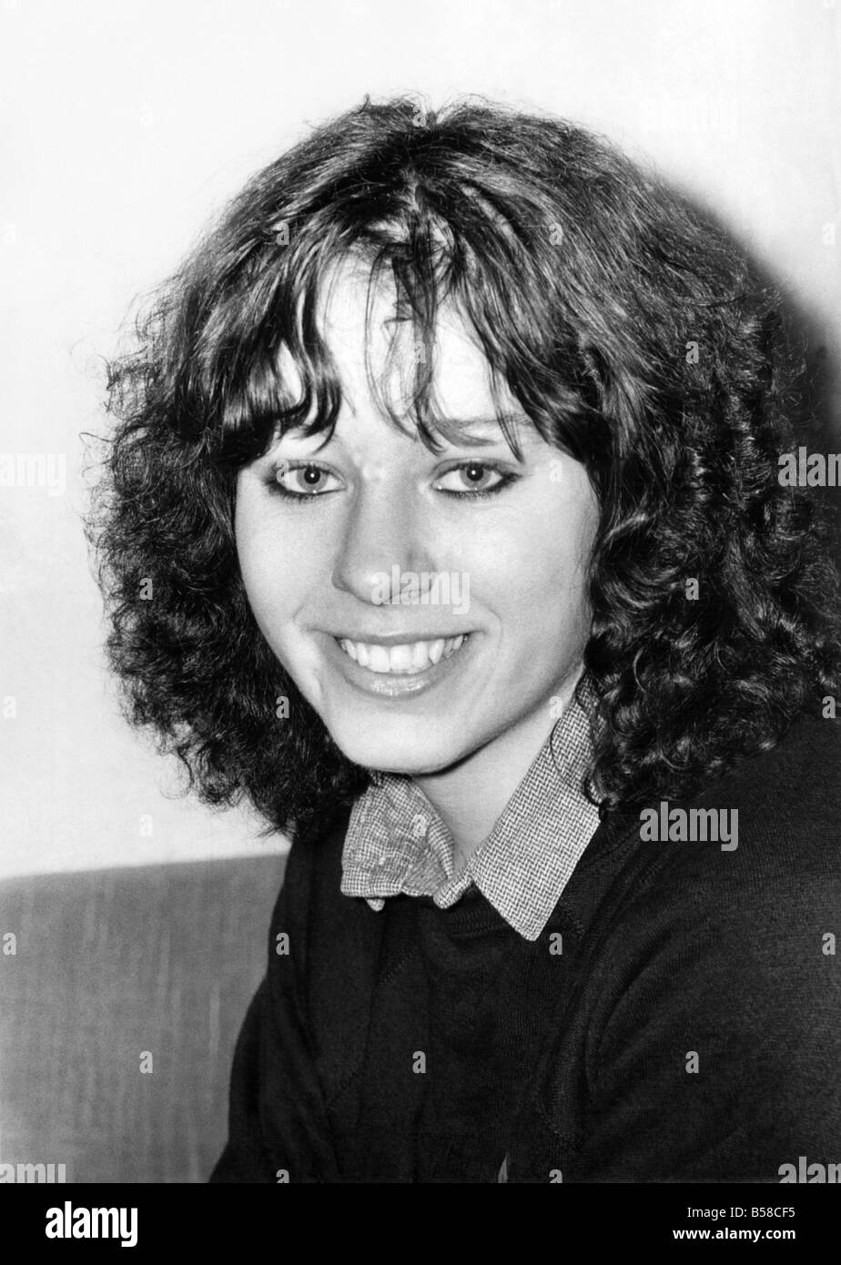 Natural Liz and just as pretty. &#13;&#10;Woman poses with jumper, collared shirt and permed hair.&#13;&#10;April 1980 P006546 Stock Photo