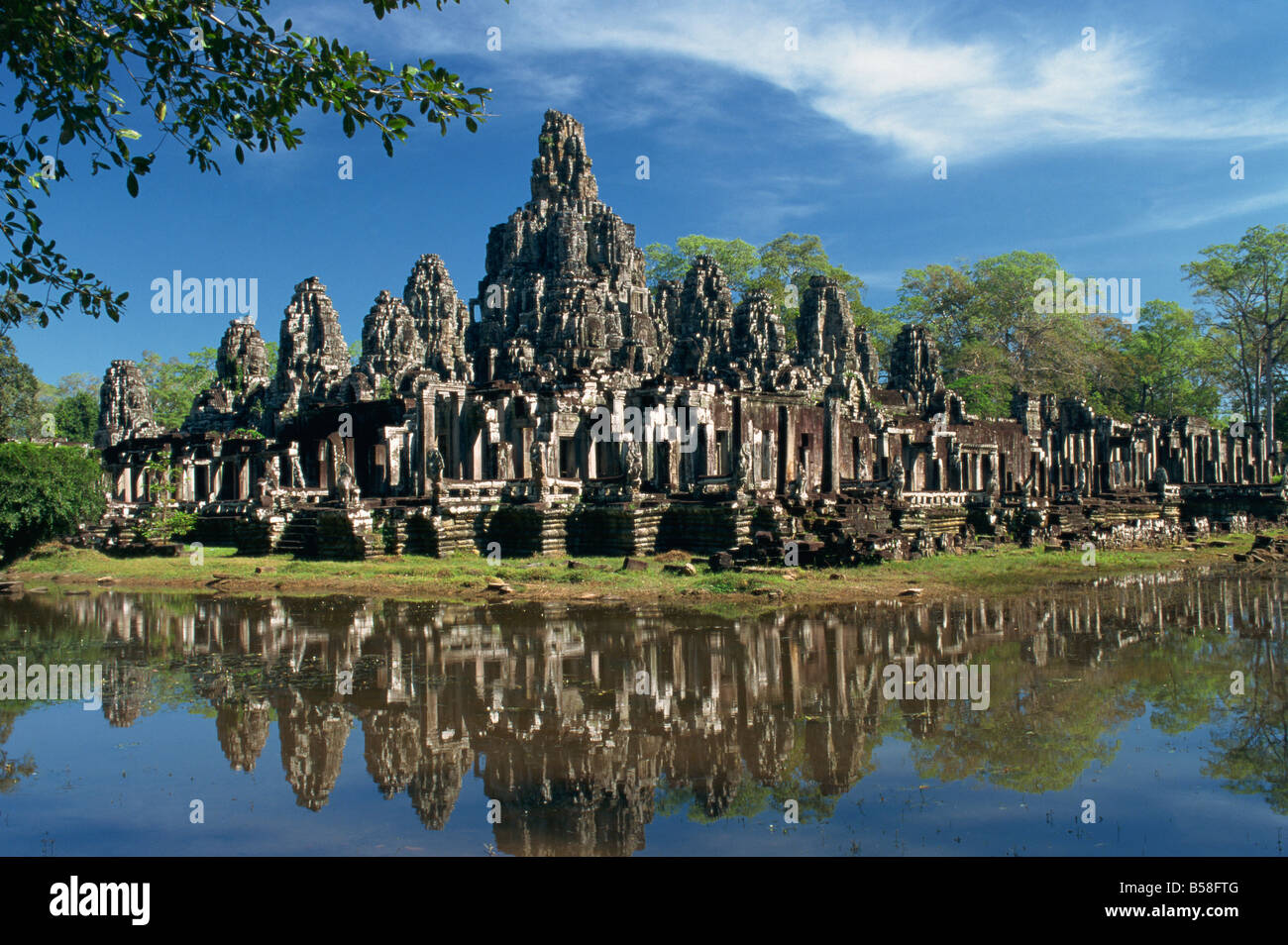 The Bayon Temple reflected in water at Angkor Wat Siem Reap Cambodia Asia G Hellier Stock Photo