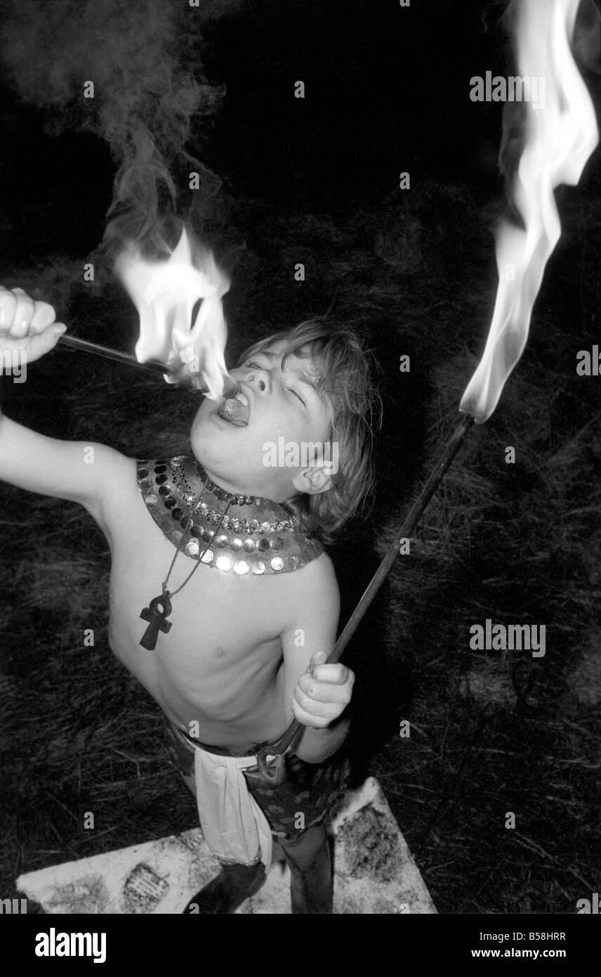 Unusual: Children. Fire Eater. 9 year old Tony Walls.Tony at his Fire Swallowing Act.  December 1976 76-07502-011 Stock Photo