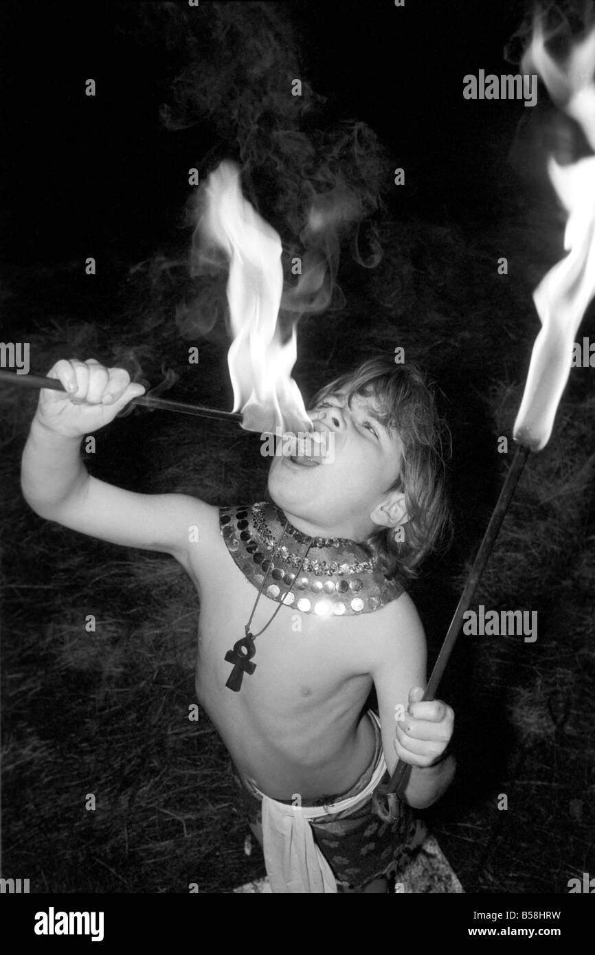 Unusual: Children. Fire Eater. 9 year old Tony Walls.Tony at his Fire Swallowing Act.  December 1976 76-07502-012 Stock Photo