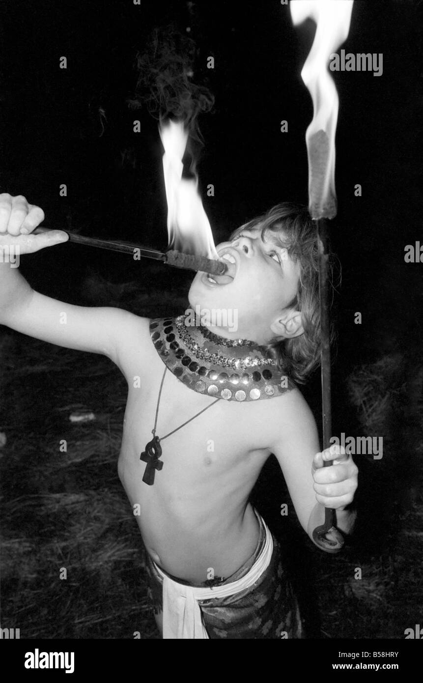 Unusual: Children. Fire Eater. 9 year old Tony Walls.Tony at his Fire Swallowing Act. December 1976 76-07502-013 Stock Photo