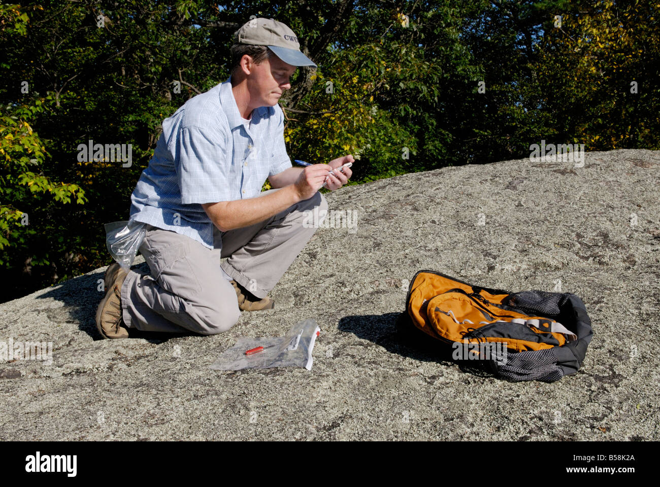 Scientist recording data, making notes in field notebook Stock Photo