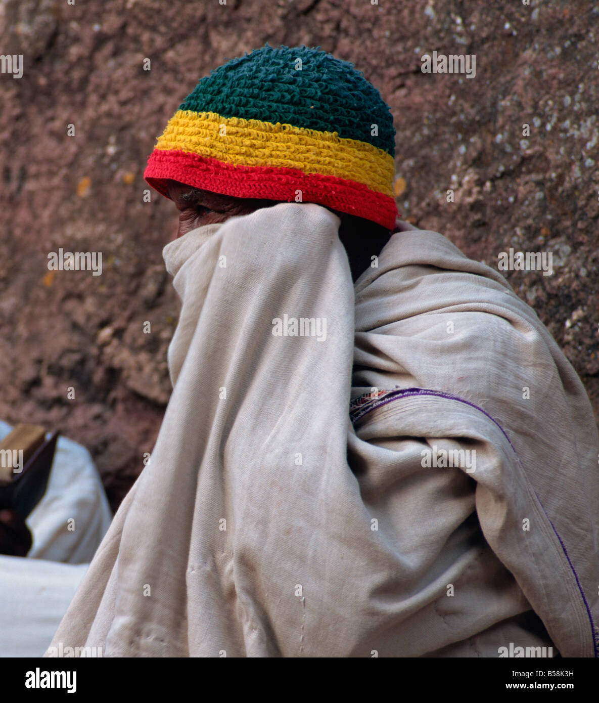 Old man in white cloth wearing hat with Ethiopian flag, Lalibela, Ethiopia, Africa Stock Photo