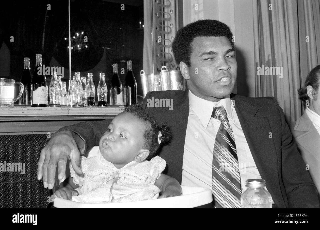 Cassius Clay. Muhammad Ali and daughter Hannah. Ali has baby sitter problems. World Champion Muhammad Ali was due to attend a press conference luncheon at the Cafe Royal to publicise his film. But there was a double snag for the ¥Champ to solve-first his baby sitter reported sick, then his wife announced that she wanted to go shopping Stock Photo