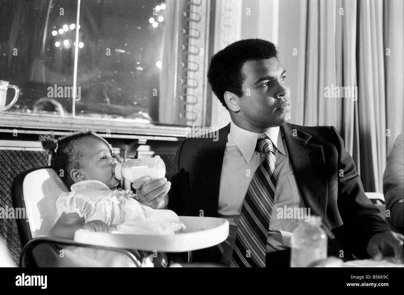 Cassius Clay. Muhammad Ali and daughter Hannah. Ali has baby sitter problems. World Champion Muhammad Ali was due to attend a press conference luncheon at the Cafe Royal to publicise his film. But there was a double snag for the Champion to solve-first his baby sitter reported sick, then his wife announced that she wanted to go shopping. Stock Photo