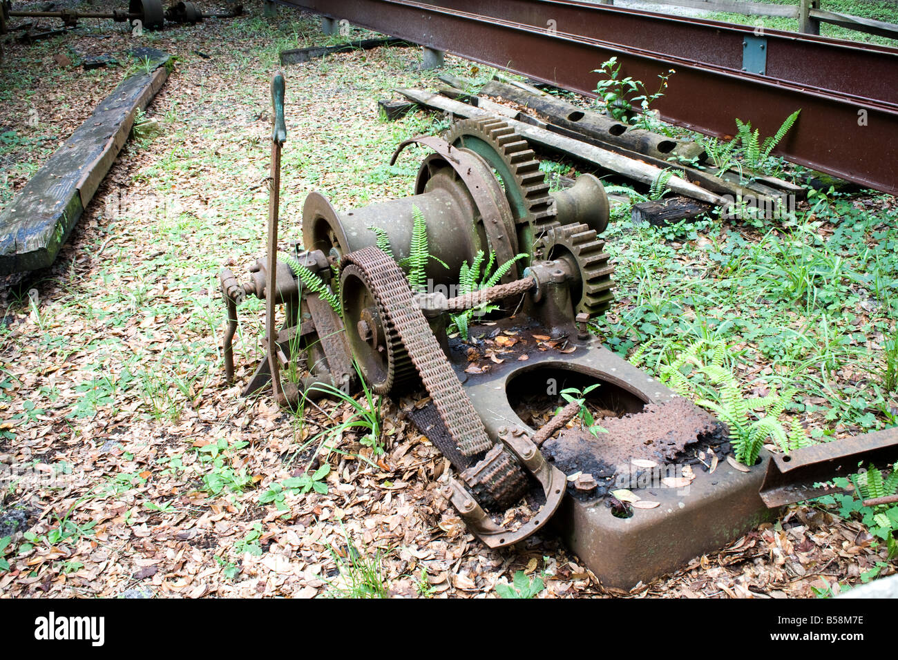 Old decaying metal machinery in the grass Stock Photo