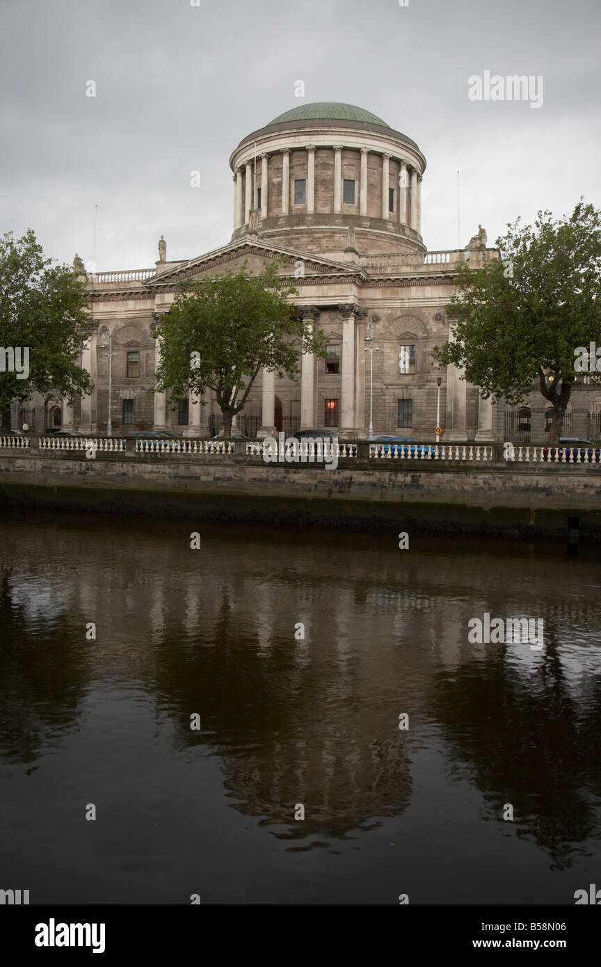 The Four Courts building on the quayside in dublin in the republic of ireland with the river liffey in the foreground 4 Stock Photo