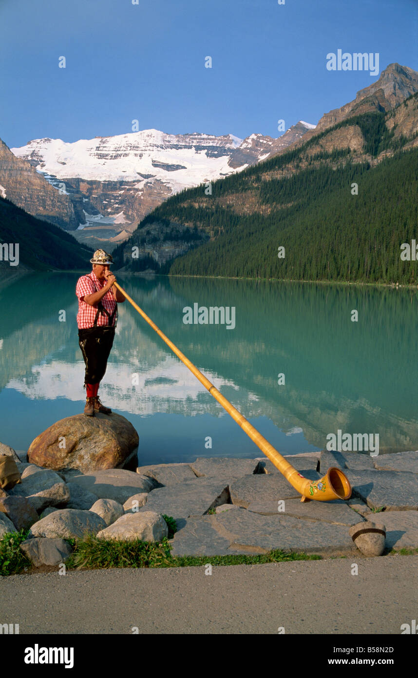 Man with an alpenhorn beside Lake Louise in the Banff National Park in Alberta Canada G Renner Stock Photo
