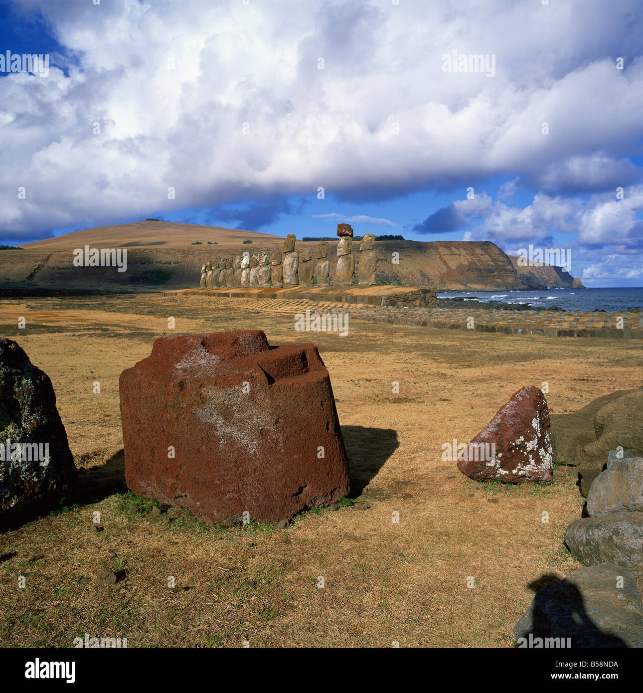 Fallen topknot in foreground Ahu Tongariki Rapa Nui National Park Easter Island Chile South America Stock Photo