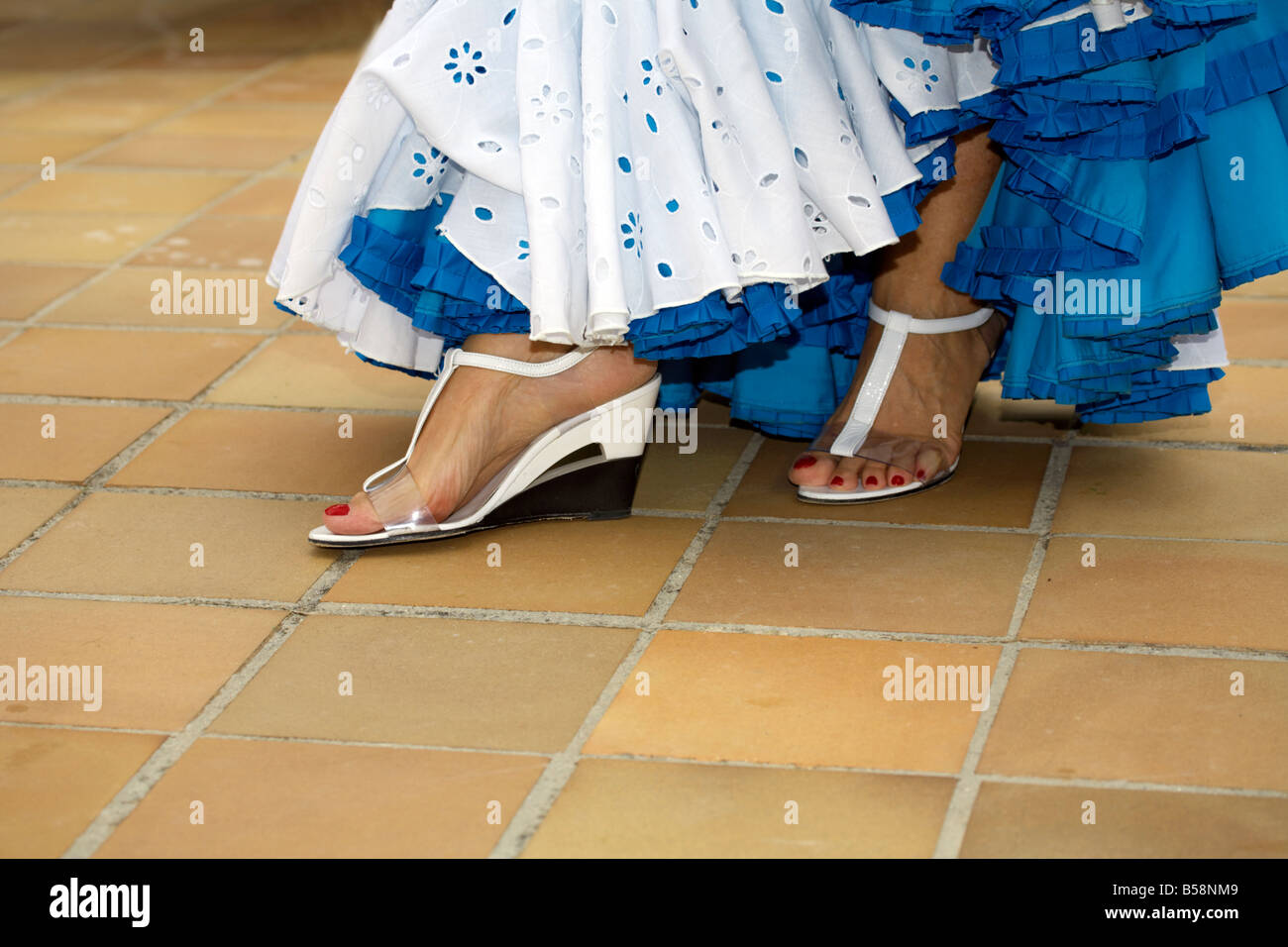 Feet of beautiful middle aged Spanish woman in traditional costume at the Fuengirola Feria, Costa del Sol, Spain, Stock Photo