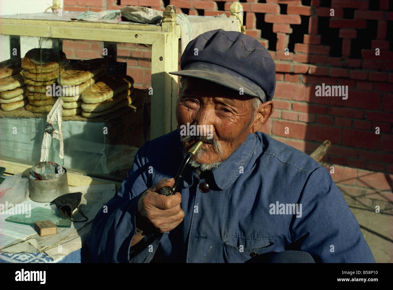 Man smoking pipe Dunhuang Gansu China Asia Stock Photo