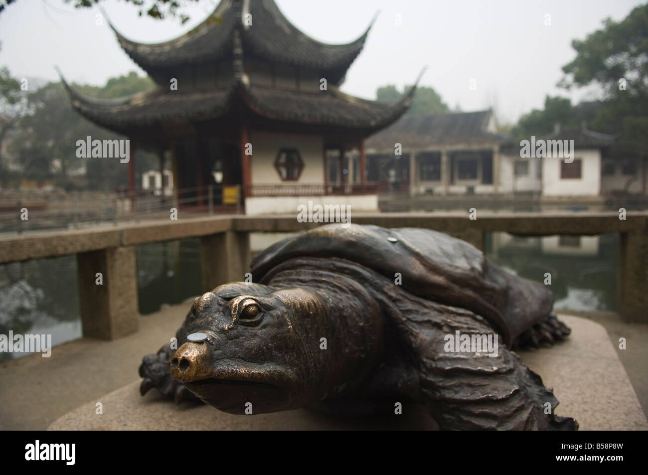 A bronze terrapin statue and pagoda at West Garden Buddhist Temple, Suzhou, Jiangsu Province, China Stock Photo
