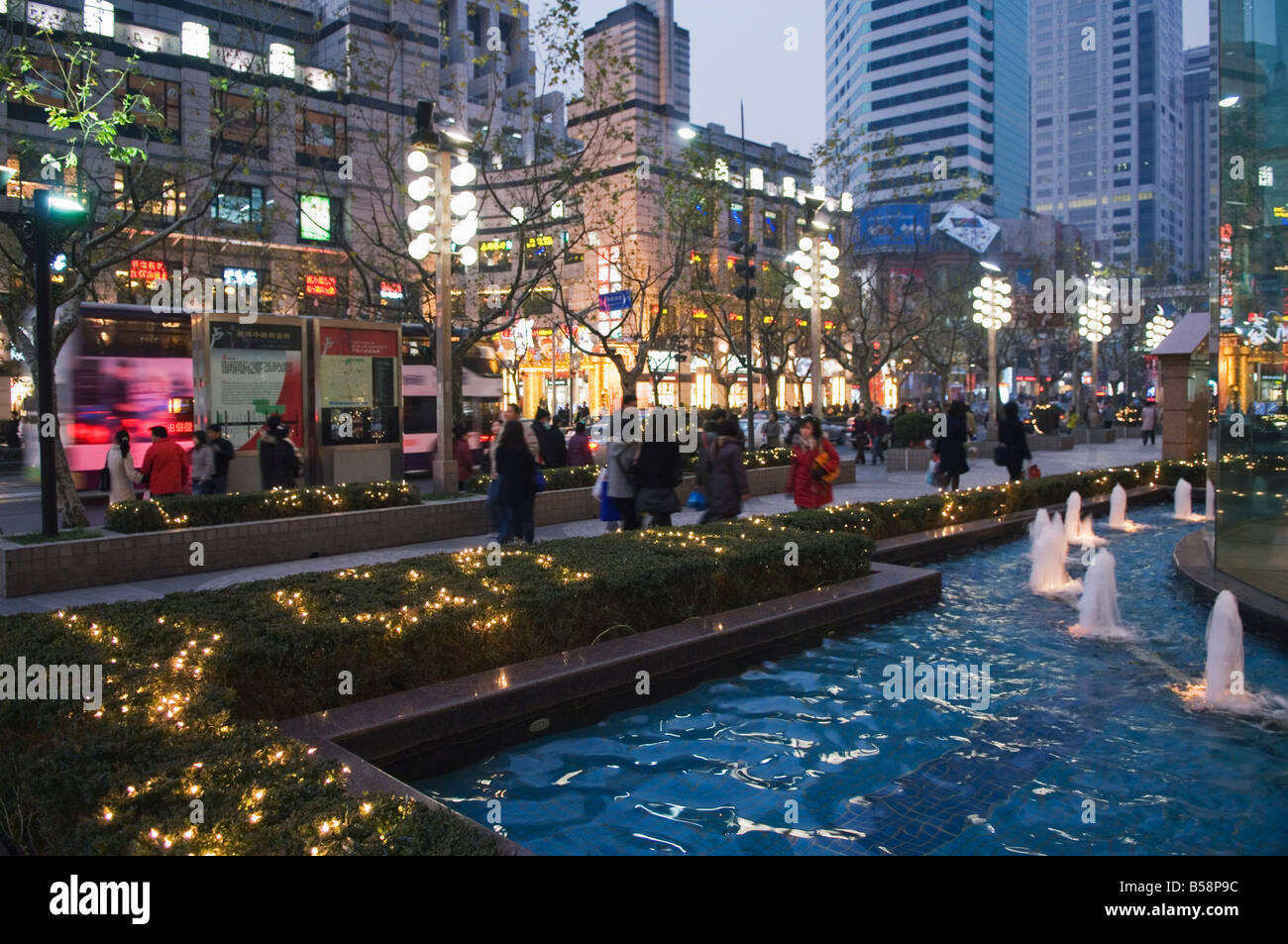 Modern displays and illuminations around a fountain in the French Concession area, Shanghai, China Stock Photo