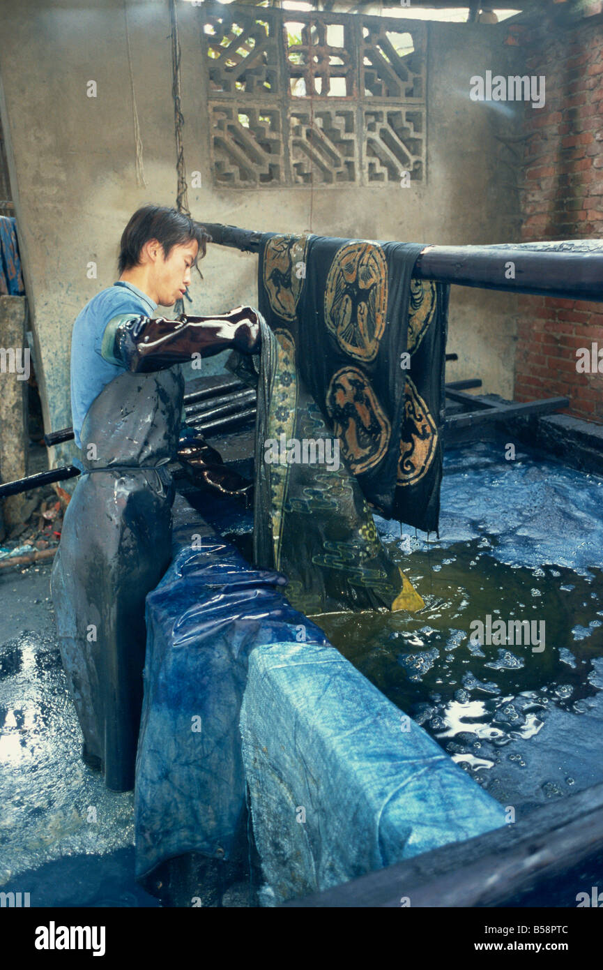 Dipping batik in an indigo vat Guizhou China Asia Stock Photo