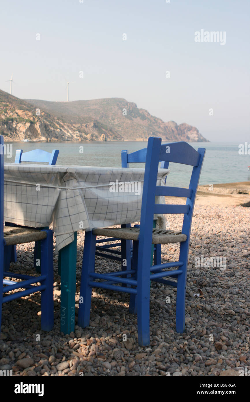 blue chairs by the sea at traditional greek taverna patmos island