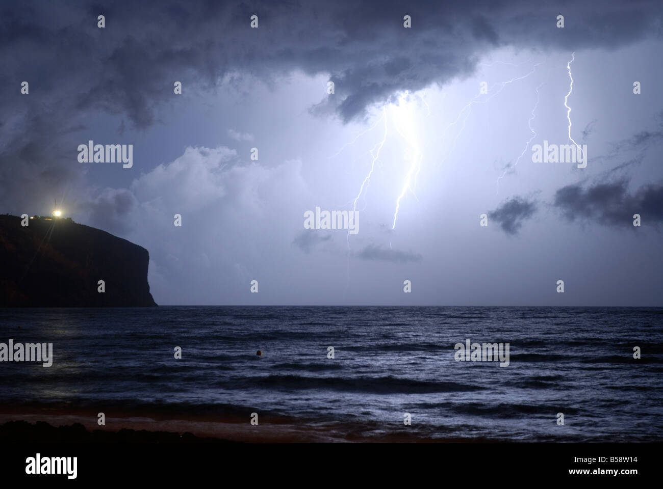 Fork lightning and storm clouds over sea & Cabo San Antonio, Javea / Xabia,  Alicante Province, Comunidad Valenciana, Spain Stock Photo