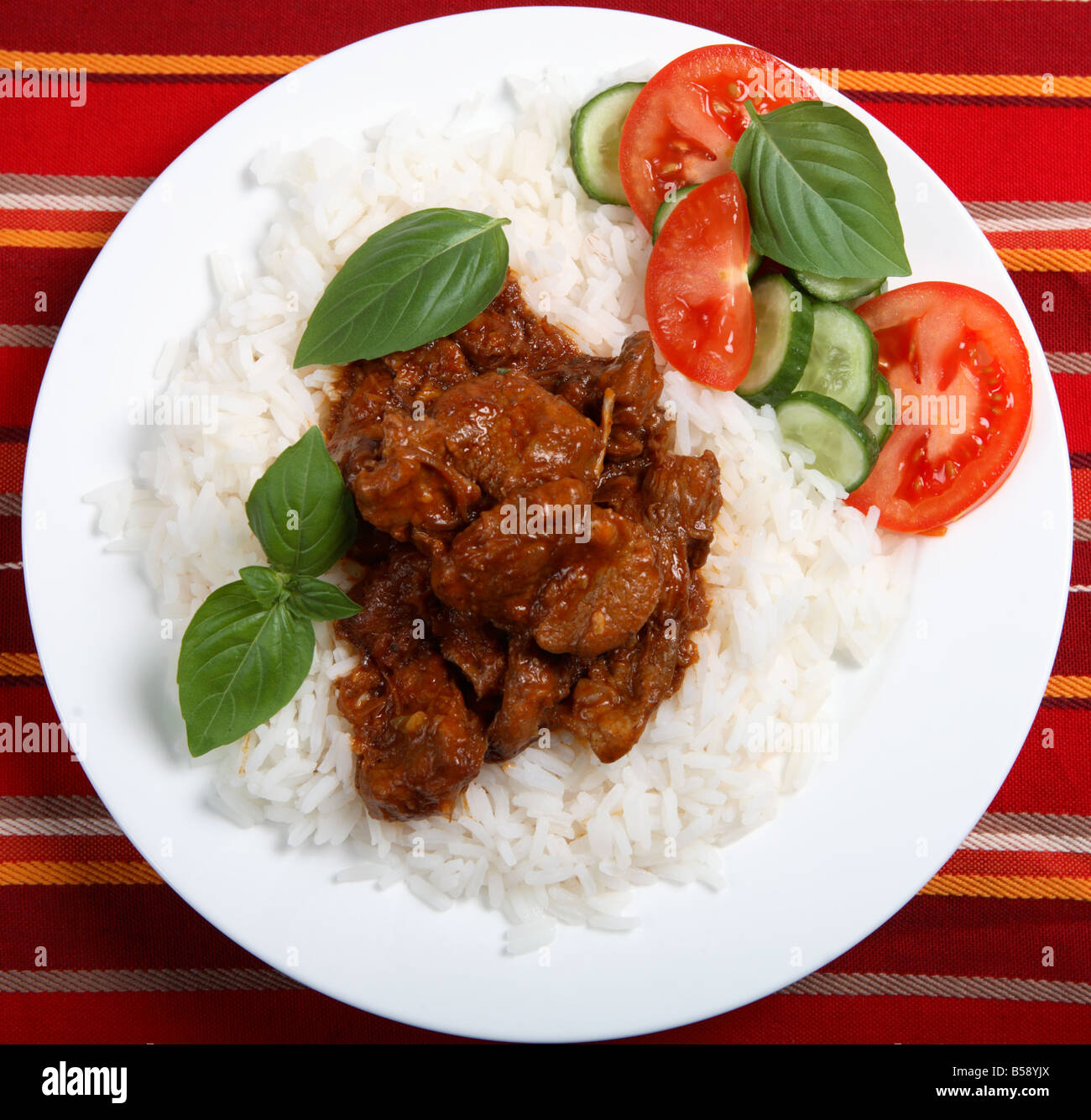 A greek style lamb in tomato sauce on white rice viewed from above