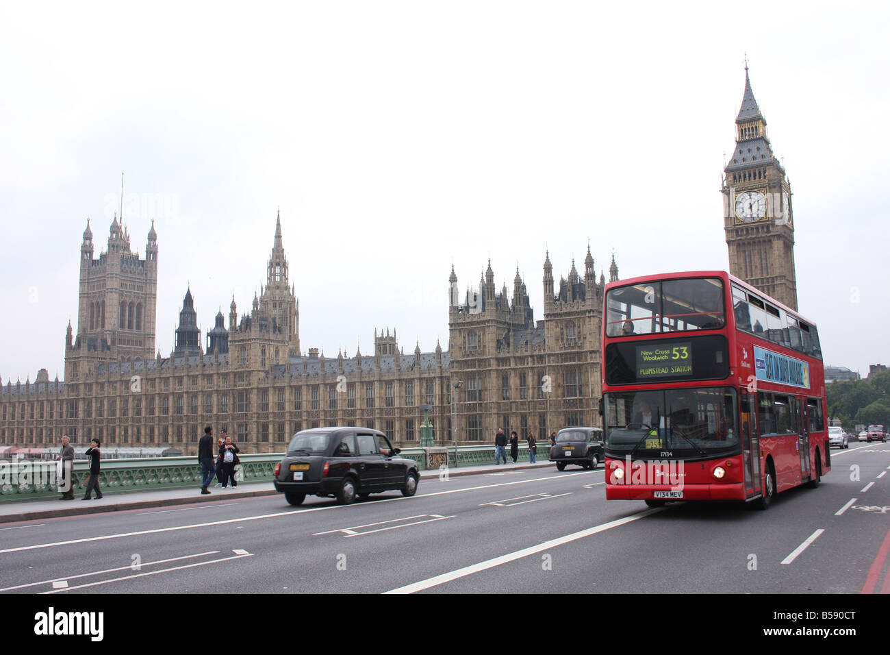 A London bus crosses the River Thames in front of Big Ben London ...