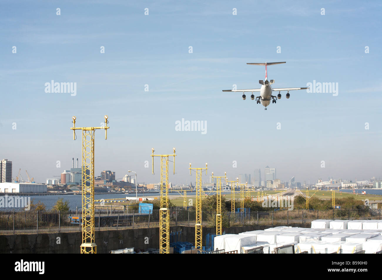 plane making approach and landing at City Airport in East London Stock Photo