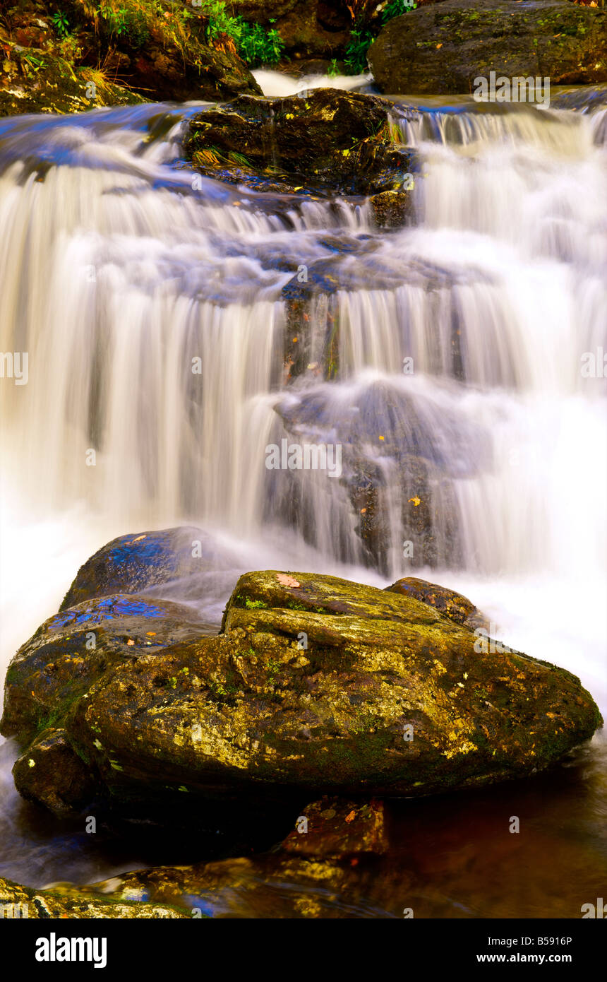 water cascading over rocks in a waterfall Stock Photo